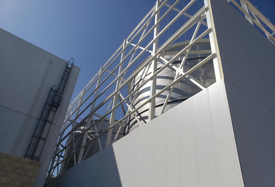 Looking up at the braced tank support frame above the wall panels